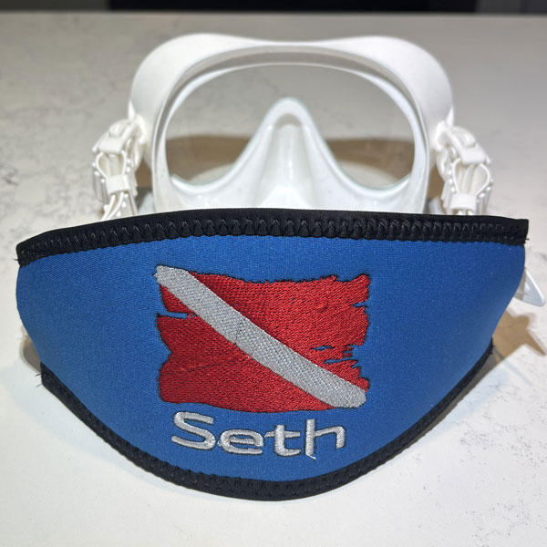 Blue scuba mask strap with a diver down flag